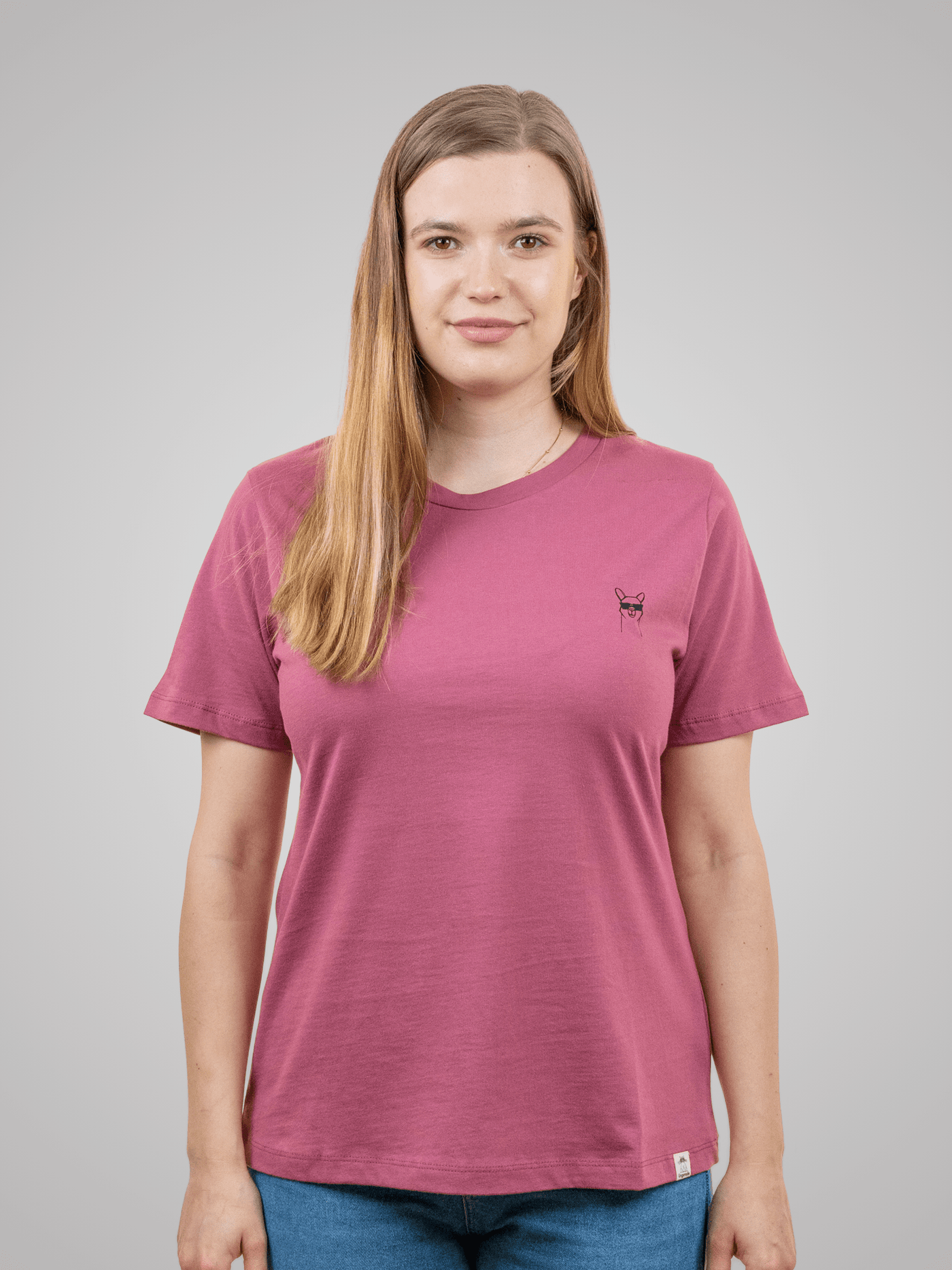 Frau mit nachhaltigem rosa Baumwollshirt mit Coolpakamotiv drinnen von vorne 